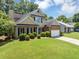 Lovely two-story home featuring a manicured lawn, brick details, and attached two car garage at 10535 Willow Meadow Cir, Alpharetta, GA 30022