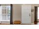 Inviting foyer with a white front door, hardwood floors, and window with natural light at 10535 Willow Meadow Cir, Alpharetta, GA 30022