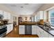 Modern kitchen featuring stainless steel appliances, granite countertops, and white cabinets at 10535 Willow Meadow Cir, Alpharetta, GA 30022