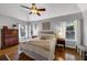 Bright main bedroom features vaulted ceiling, hardwood floors, and plentiful natural light from multiple windows at 10535 Willow Meadow Cir, Alpharetta, GA 30022