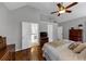 Cozy main bedroom with vaulted ceiling, hardwood floors, ceiling fan, and adjoining bath at 10535 Willow Meadow Cir, Alpharetta, GA 30022