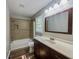Bathroom vanity featuring a large vanity mirror and tiled shower at 180 Bishop Nw Rd, Cartersville, GA 30121