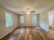A spacious bedroom with wood floors, large windows, and a ceiling fan with light fixture at 180 Bishop Nw Rd, Cartersville, GA 30121