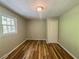 A bright bedroom featuring wood flooring, a window, and a ceiling light for a cozy atmosphere at 180 Bishop Nw Rd, Cartersville, GA 30121