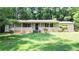 Charming single-story home featuring a well-maintained lawn and inviting front porch with brick accents at 180 Bishop Nw Rd, Cartersville, GA 30121