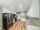 Bright kitchen featuring stainless steel appliances, granite countertops, and ample white cabinetry at 180 Bishop Nw Rd, Cartersville, GA 30121