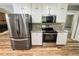 Updated kitchen with stainless steel appliances, granite countertops and mosaic backsplash at 180 Bishop Nw Rd, Cartersville, GA 30121