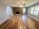 Spacious living room with hardwood floors, brick fireplace, and lots of natural light at 180 Bishop Nw Rd, Cartersville, GA 30121