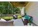 Covered back patio featuring cushioned seating and a view of the yard, creating a comfortable outdoor space at 2140 Hurt Sw Rd, Marietta, GA 30008