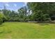 Spacious backyard with lush green grass and a wooden fence, perfect for outdoor activities and relaxation at 2140 Hurt Sw Rd, Marietta, GA 30008