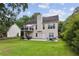 The back of the home features a deck, a patio with seating, and a lush green yard, perfect for outdoor living at 2140 Hurt Sw Rd, Marietta, GA 30008