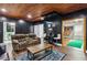 Finished basement with paneled accent wall, movie posters, large TV, and comfortable seating at 2140 Hurt Sw Rd, Marietta, GA 30008