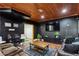 Finished basement with paneled accent wall, movie posters, large TV, and comfortable seating at 2140 Hurt Sw Rd, Marietta, GA 30008