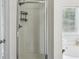 Modern bathroom featuring glass shower, neutral colors, and a window allowing natural light at 2140 Hurt Sw Rd, Marietta, GA 30008
