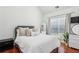 Bright bedroom with hardwood floors, a large window, and tasteful decor, creating a serene atmosphere at 2140 Hurt Sw Rd, Marietta, GA 30008