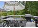 Outdoor deck featuring a large table with chairs, a grill, and an umbrella, ideal for entertaining guests at 2140 Hurt Sw Rd, Marietta, GA 30008