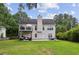 The back of the house has a deck, a patio with seating, and a lush green yard, perfect for outdoor living at 2140 Hurt Sw Rd, Marietta, GA 30008