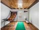 Finished basement with paneled accent wall featuring an indoor basketball game, golf putting green and accessories at 2140 Hurt Sw Rd, Marietta, GA 30008
