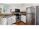 Well-lit kitchen with stainless steel appliances and tile backsplash at 2140 Hurt Sw Rd, Marietta, GA 30008