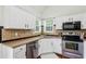 Functional kitchen with stainless steel appliances, tile backsplash and eat-in breakfast nook at 2140 Hurt Sw Rd, Marietta, GA 30008