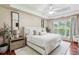 Serene main bedroom with tray ceiling, fan, and ample natural light at 2140 Hurt Sw Rd, Marietta, GA 30008