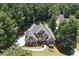 Aerial view of a beautiful two-story home, featuring a well-maintained lawn and professional landscaping at 2832 Windrush Dr, Buford, GA 30518
