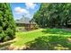 Spacious green backyard featuring a deck and a view of the home's back at 2832 Windrush Dr, Buford, GA 30518