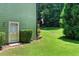 Green backyard with door to home and green-sided exterior at 2832 Windrush Dr, Buford, GA 30518