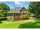 Green backyard with a deck and a green-sided home exterior at 2832 Windrush Dr, Buford, GA 30518