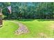 Spacious green backyard featuring rock drainage and an American flag at 2832 Windrush Dr, Buford, GA 30518