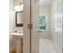 Half bathroom features a pedestal sink, wainscoting, and a window with a view at 2832 Windrush Dr, Buford, GA 30518