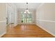 Bright dining room with hardwood floors, large window, and contemporary chandelier at 2832 Windrush Dr, Buford, GA 30518