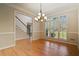 Bright dining room with hardwood floors and modern light fixture at 2832 Windrush Dr, Buford, GA 30518