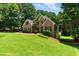 Beautiful brick home with a well-kept lawn and mature landscaping at 2832 Windrush Dr, Buford, GA 30518