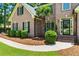 Close-up of a lovely brick home with a welcoming entrance and trimmed landscaping at 2832 Windrush Dr, Buford, GA 30518