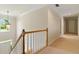 Upstairs hallway with carpet and wooden railings at 2832 Windrush Dr, Buford, GA 30518