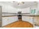 Bright kitchen with white cabinets, granite countertops, and stainless steel appliances at 2832 Windrush Dr, Buford, GA 30518