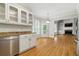 Modern kitchen with white cabinetry, stainless steel appliances, and hardwood floors at 2832 Windrush Dr, Buford, GA 30518