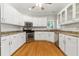 Well-lit kitchen featuring white cabinets, stainless steel appliances, and granite countertops at 2832 Windrush Dr, Buford, GA 30518