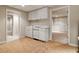 View of the basement kitchenette that offers white cabinets and a white appliance suite at 2832 Windrush Dr, Buford, GA 30518