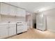 View of the basement kitchenette with a white appliance suite and tile flooring at 2832 Windrush Dr, Buford, GA 30518