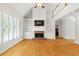 Bright living room features a fireplace, built-ins, and hardwood floors at 2832 Windrush Dr, Buford, GA 30518