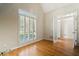 Bright room with vaulted ceiling, hardwood floors, and large windows with plantation shutters at 2832 Windrush Dr, Buford, GA 30518