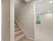 View of the carpeted stairs that lead to the basement featuring neutral decor at 2832 Windrush Dr, Buford, GA 30518
