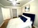 Cozy bedroom with hardwood floors and a comfortable bed with white linens and dark blue accent pillows at 300 Peachtree Ne St # 11I, Atlanta, GA 30308