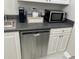 Small kitchenette area featuring a microwave, coffee maker, sink, and ample counter space at 300 Peachtree Ne St # 11I, Atlanta, GA 30308