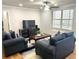 Comfortable living room with dark sofas, wooden flooring, and a large window for natural light at 300 Peachtree Ne St # 11I, Atlanta, GA 30308