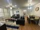 Well-lit living and dining area with dark sofas, a wooden dining table, and modern decor at 300 Peachtree Ne St # 11I, Atlanta, GA 30308