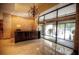 Building lobby featuring a dark wood reception desk, marble flooring, and glass entrance at 300 Peachtree Ne St # 11I, Atlanta, GA 30308