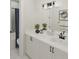 Bright bathroom with a double vanity, sleek fixtures, and a view of a bathtub shower combination at 947 Willingham Dr # 2, Hapeville, GA 30354